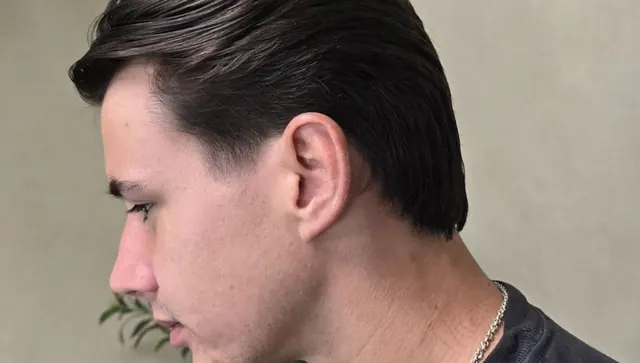 A slicked-back cut with a tapered neckline